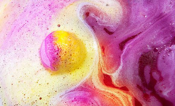 pink and yellow bath bomb in water